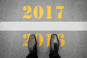 Black shoes standing at the line between last year 2016 and new year 2017